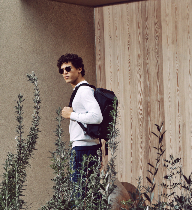 Shows Picture of man-with-porsche-design-backpack-white-longsleeve-wearing-sunglasses.png