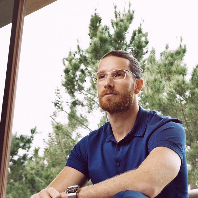 Shows Picture of man-with-glasses-sitting-on-leatherchair.png
