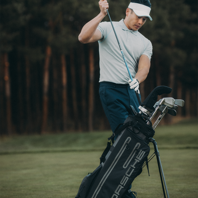 Shows Picture of Golf_Standbag_on_Grass_Man_Getting_Golfclub.png