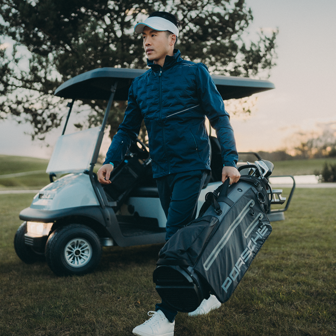 Shows Picture of man-carrying-golfbag-on-court.png