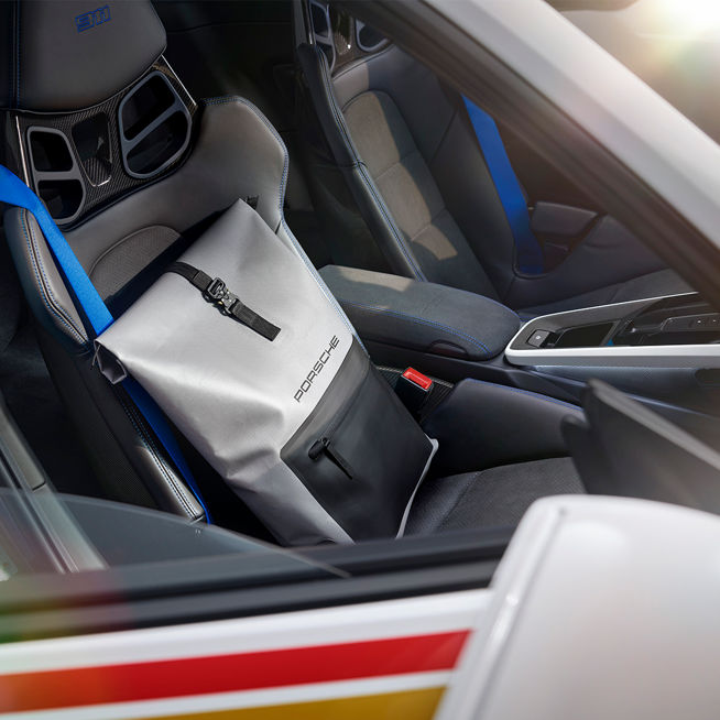 Shows Picture of Rolltop_Rucksack_on_Porsche_Car_Seat_Roughroads.png